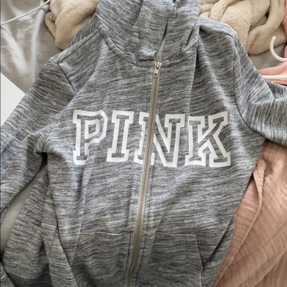 a grey zipper up from pink